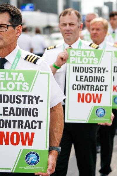 Delta Air Lines pilots picket during a nationwide protest against the union contract at Atlanta Hartsfield-Jackson International Airport in Atlanta, Georgia, US, on Thursday, June 30, 2022.