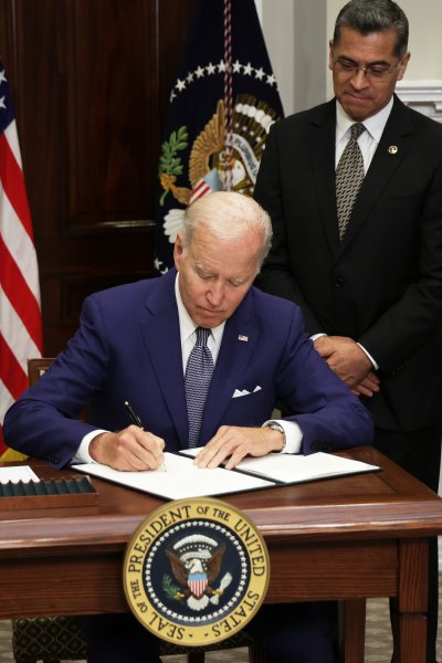 President Joe Biden signs an executive order on access to reproductive health care services as (L-R) Vice President Kamala Harris, Secretary of Health and Human Services Xavier Becerra, and Deputy Attorney General Lisa Monaco look on during an event at the Roosevelt Room of the White House