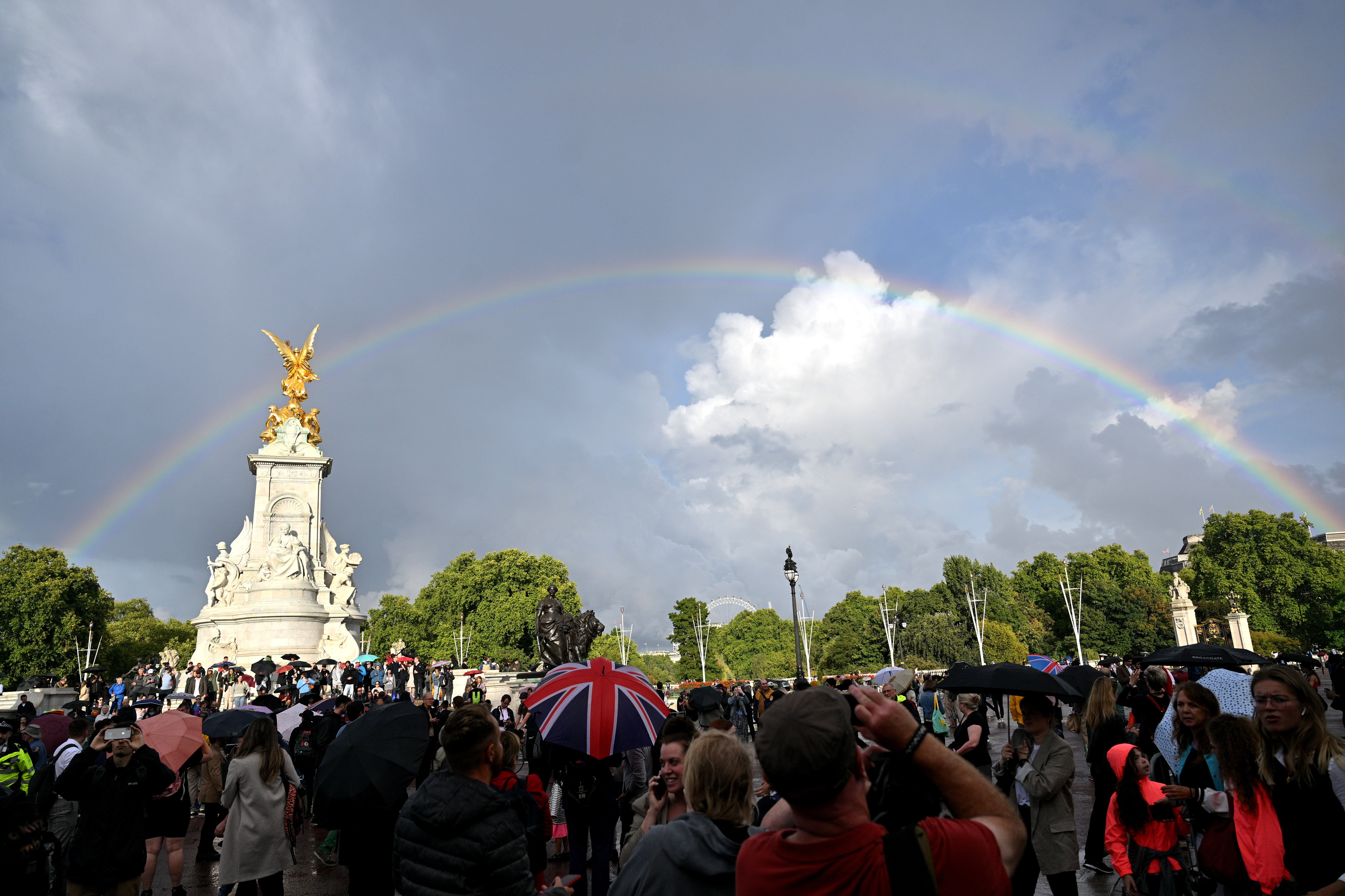 A rainbow fills the sky outside of Buckingham Palace