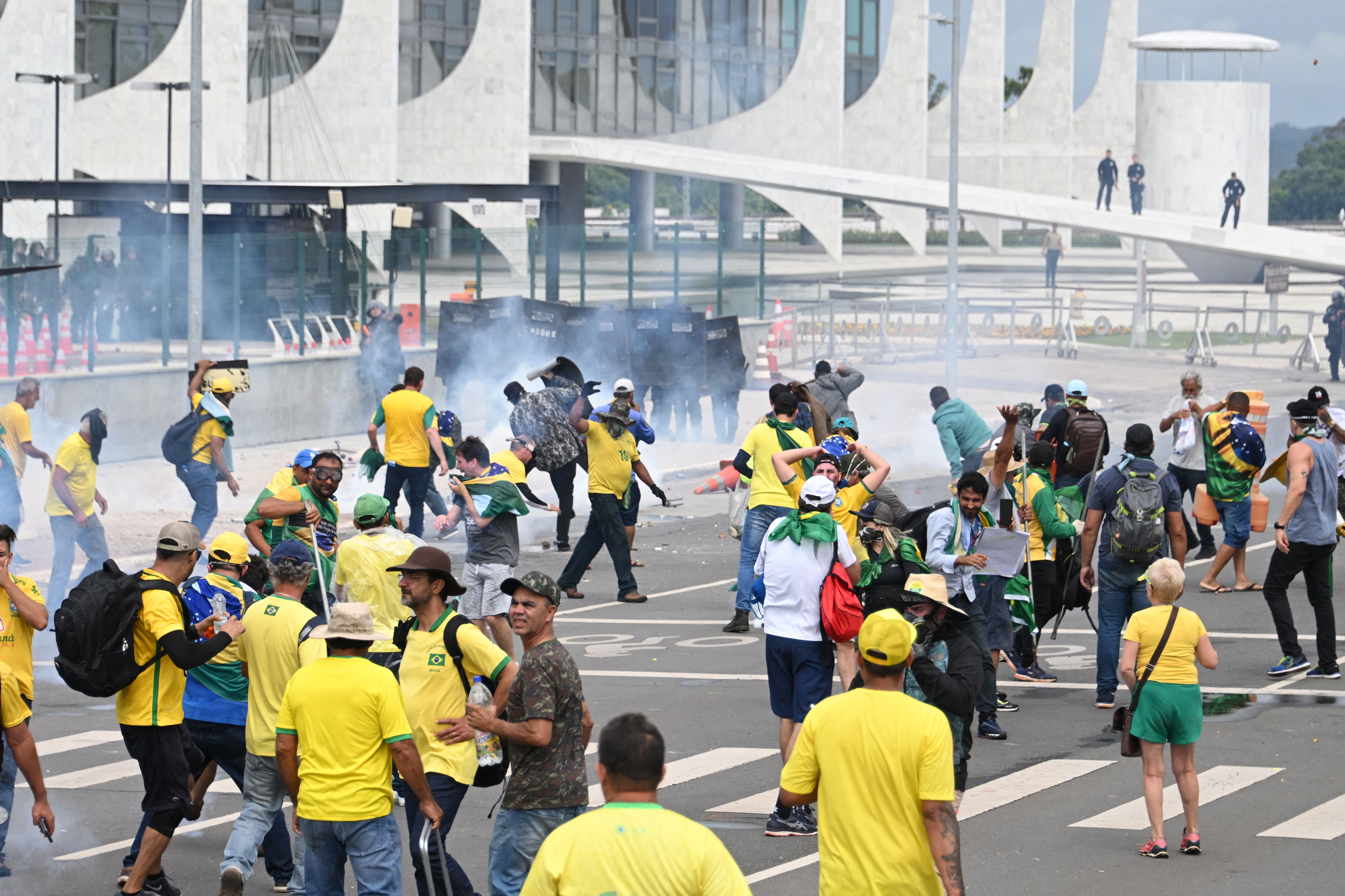 Supporters of Brazilian former President Jair Bolsonaro clash with the police during a demonstration outside the Planalto Palace